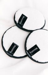 white reusable makeup removing pad with a black border and a black 'Beginning' label