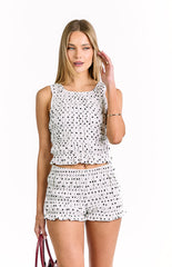 featuring tiered ruffles and an elasticated waistband. Perfectly with sleeveless crop top with tiered ruffles in a white and black polka dot print