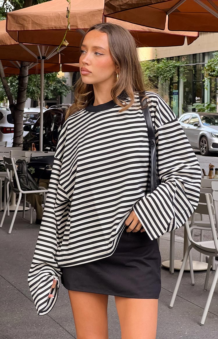 blonde girl wearing a black linen mini skort paired with a white crop top