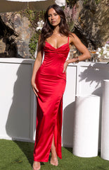 Brunette model wearing a red maxi dress and clear heels outdoors.